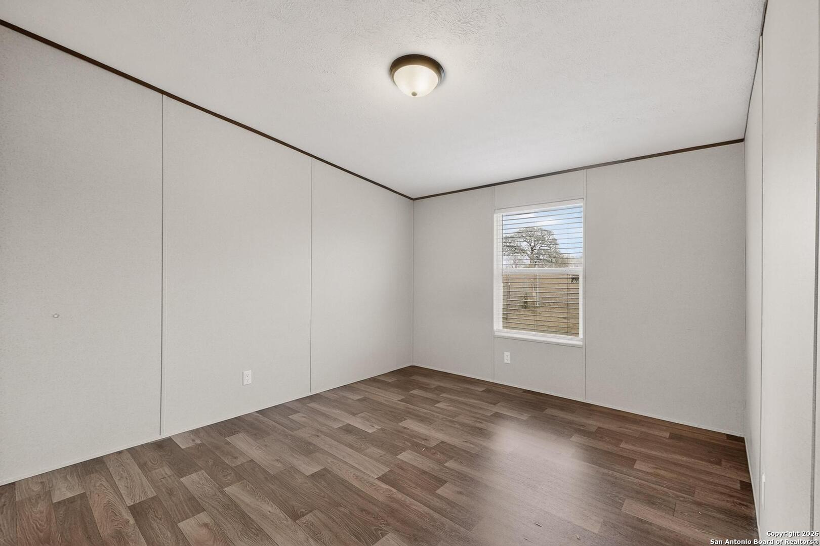 19124 La Gloria Road Elmendorf, TX 78112 - Photo 33 of 45 a view of an empty room with a window