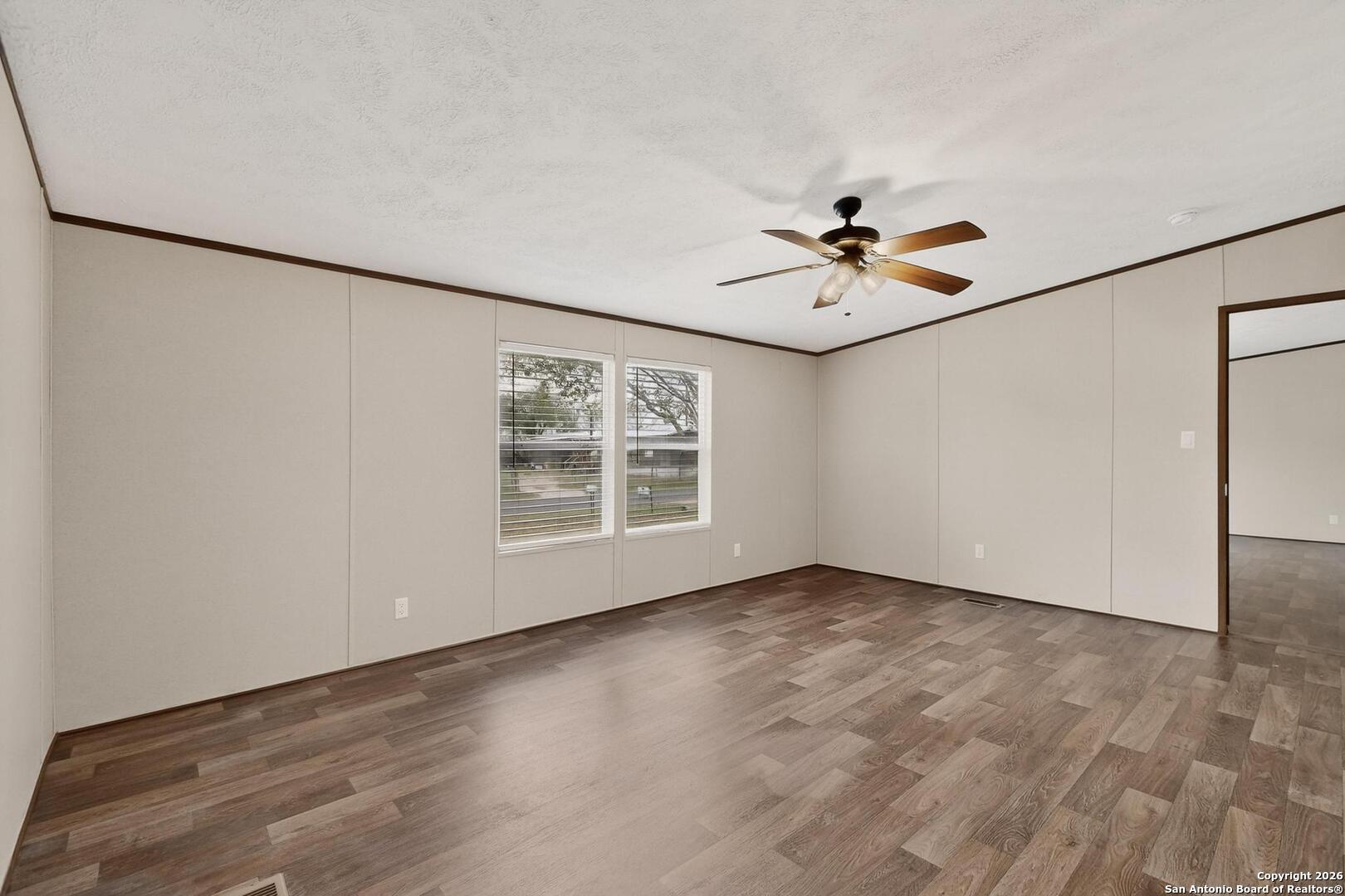 19124 La Gloria Road Elmendorf, TX 78112 - Photo 35 of 45 wooden floor in an empty room with a window