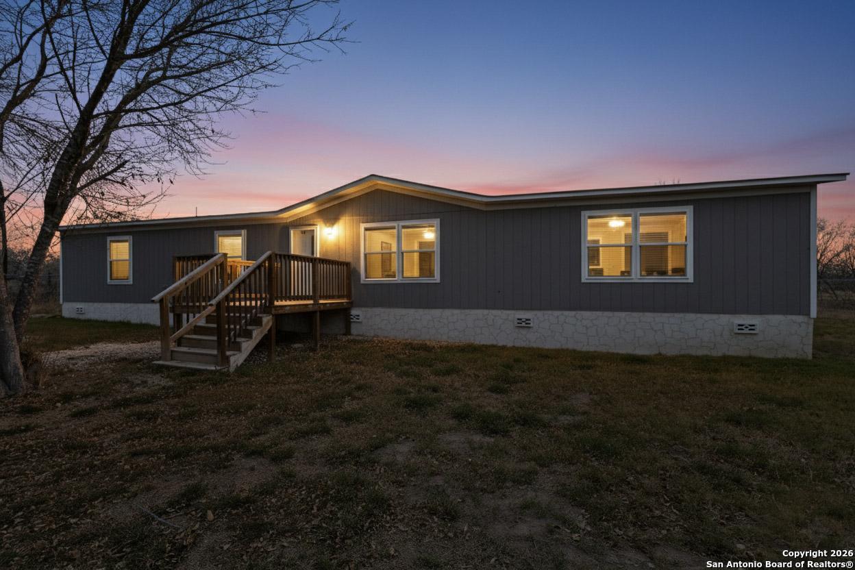 19124 La Gloria Road Elmendorf, TX 78112 - Photo 4 of 45 a front view of a house with a yard