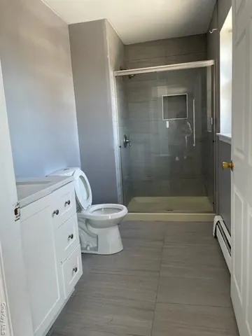 a bathroom with a shower and a toilet