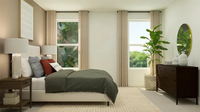 a bedroom with a bed windows and a potted plant