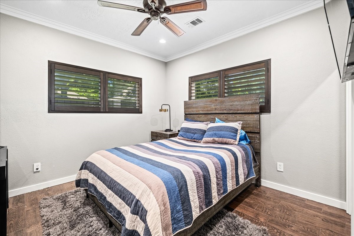 1502 Reimer Street Brenham, TX 77833 - Photo 20 of 30 a bedroom with a bed and painting on the wall