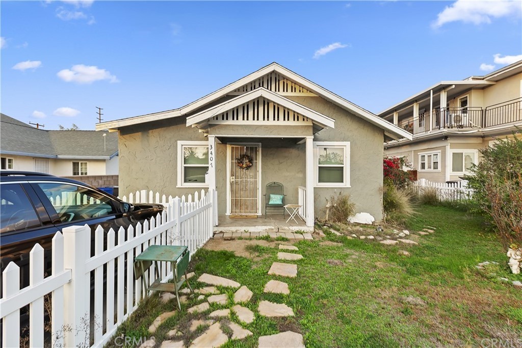 3407 Spruce Street Riverside, CA 92501 - Photo 1 of 1 a front view of a house with garden