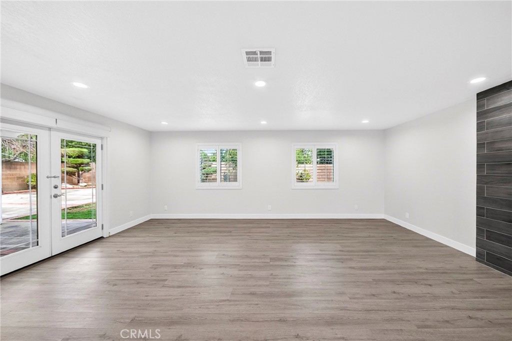 19361 Plummer Street Northridge, CA 91324 - Photo 24 of 42 an empty room with wooden floor and windows