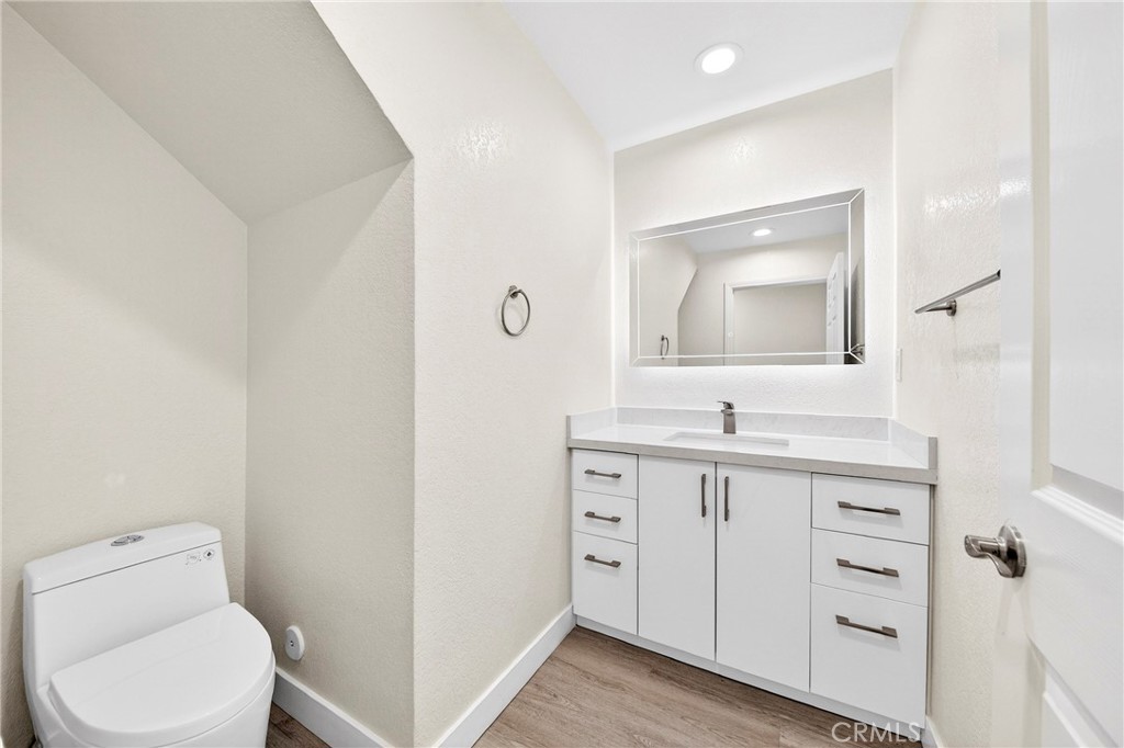 19361 Plummer Street Northridge, CA 91324 - Photo 29 of 42 a bathroom with a toilet a sink a vanity and mirror
