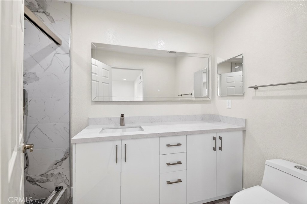 19361 Plummer Street Northridge, CA 91324 - Photo 38 of 42 a bathroom with a sink and a toilet