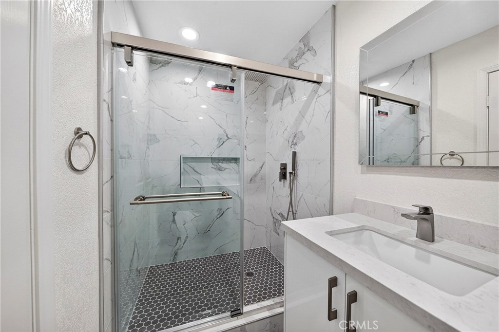 19361 Plummer Street Northridge, CA 91324 - Photo 39 of 42 a bathroom with a sink shower and a mirror