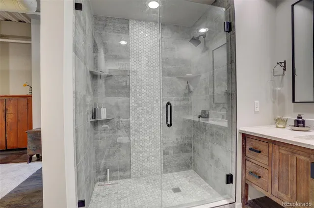 a bathroom with a shower sink and mirror