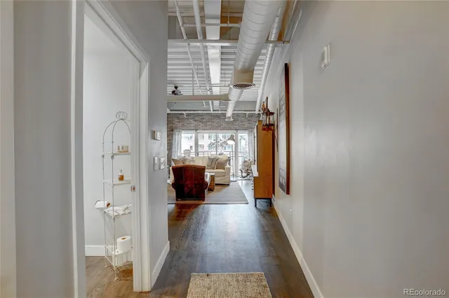 a view of entryway and hall with wooden floor
