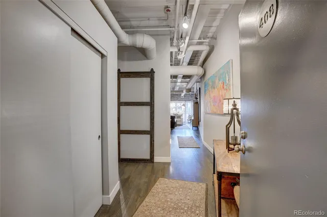 a view of entryway and hall with wooden floor