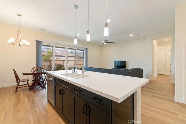 a kitchen with a table chairs and wooden floor