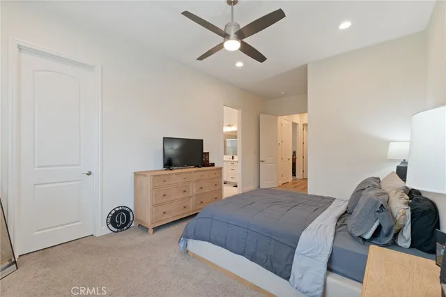 a bedroom with a bed a window and a television