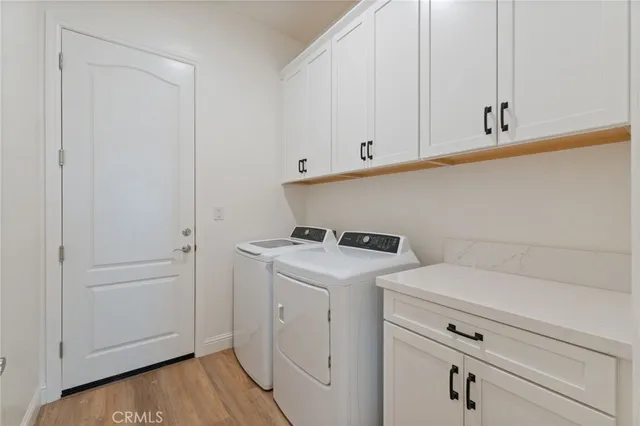 a view of storage and utility room with washer and dryer