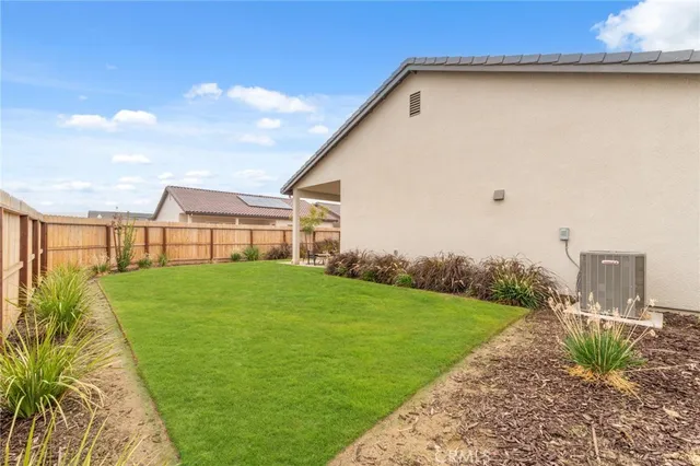 a view of a backyard with plants and a garden
