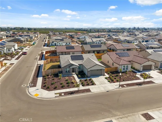 an aerial view of a residential houses with city view