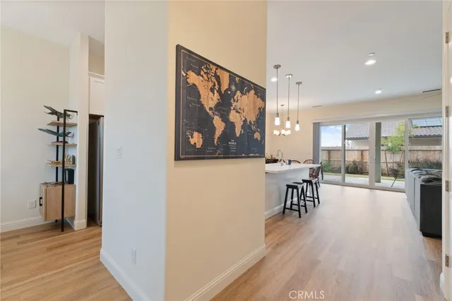 a view of a hallway with furniture and wooden floor