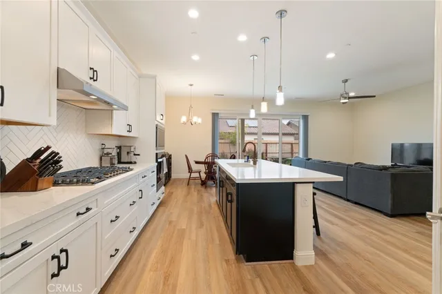 a large kitchen with stainless steel appliances kitchen island granite countertop a large island in the center