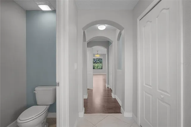 a view of a workspace with wooden floor and a ceiling fan