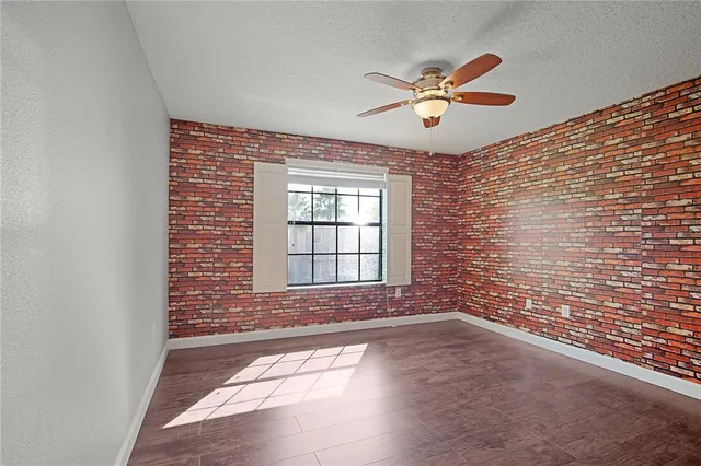 a view of a room with lots of wooden furniture and a chandelier