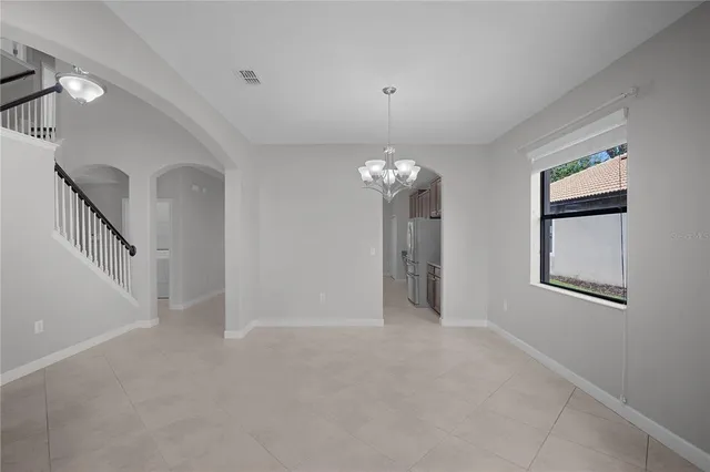 a view of a chandelier in big room and chandelier