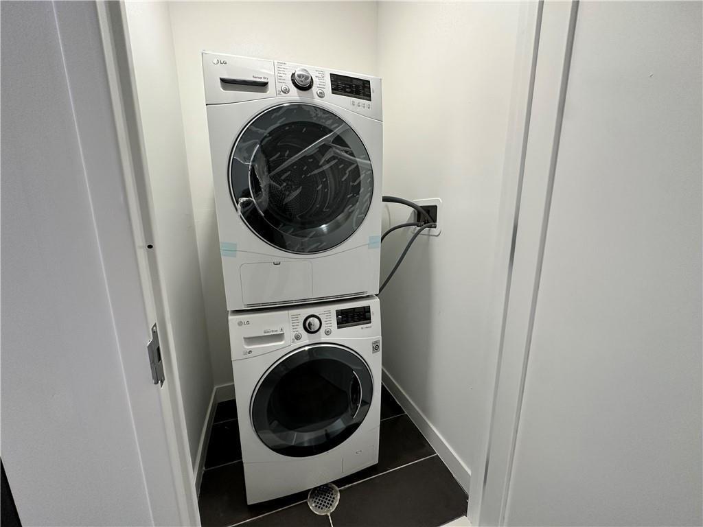 1238 63rd Street, Unit 449 Brooklyn, NY 11219 - Photo 4 of 5 a utility room with dryer and washer