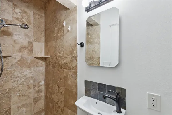 a bathroom with a sink and shower