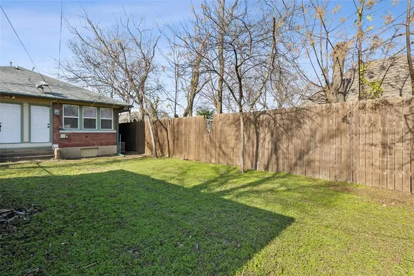 a backyard of a house with yard and barbeque oven
