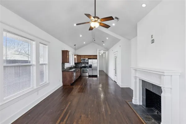 a view of a living room a window and kitchen view