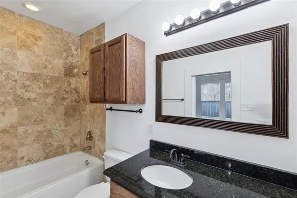 a bathroom with a sink a toilet and a mirror