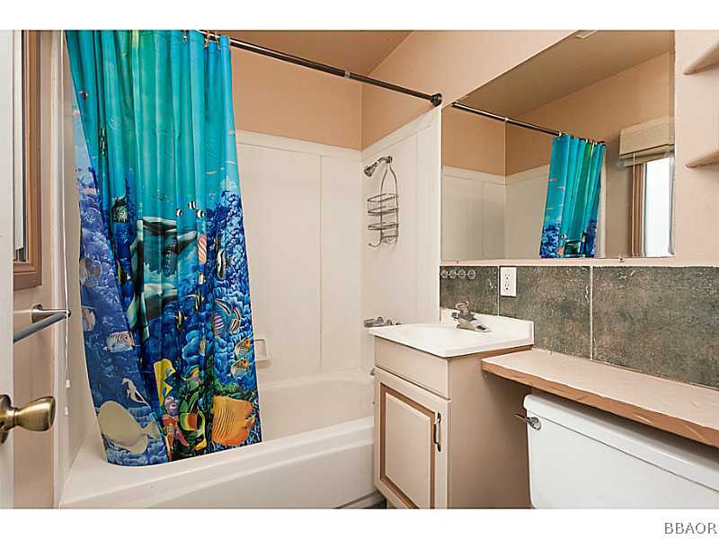 609 Riverside Avenue Sugarloaf, CA 92386 - Photo 17 of 25 a bathroom with a sink and a mirror