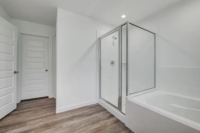 a bathroom with a bathtub and a shower