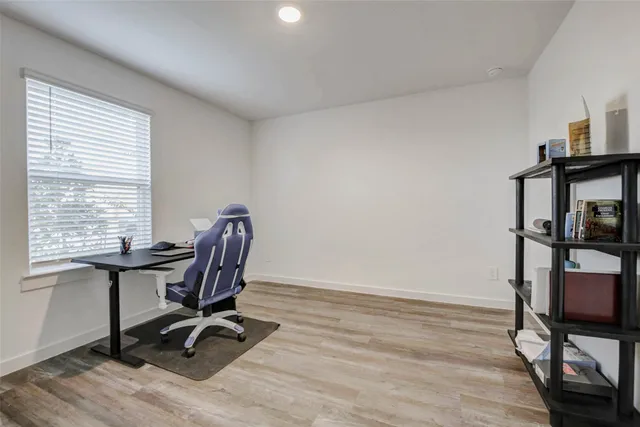 a view of a workspace with furniture and a window