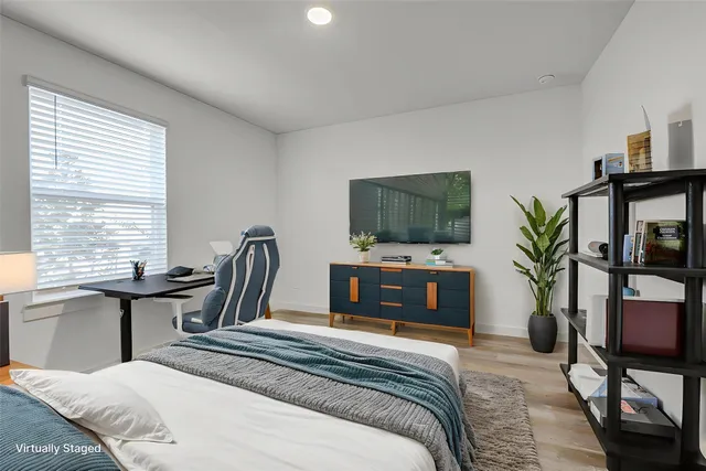 a bedroom with a bed and a flat screen tv