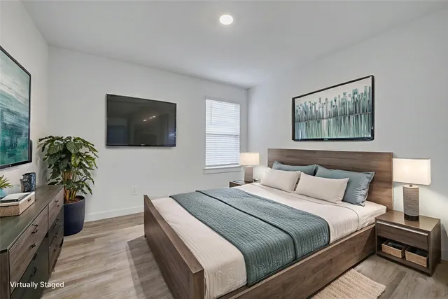 a bedroom with a bed and a flat screen tv