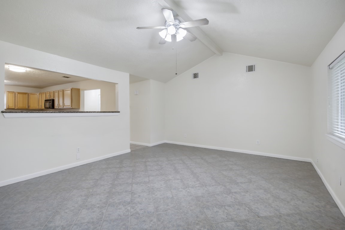 3203 Willie Way Spring, TX 77380 - Photo 19 of 31 an empty room with a chandelier fan and windows