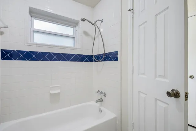 a bathroom with a bathtub and a shower