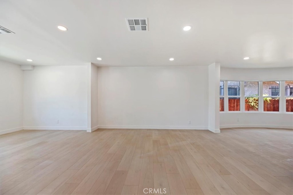 3011 5th Los Angeles, CA 90018 - Photo 13 of 44 an empty room with wooden floor and shelves
