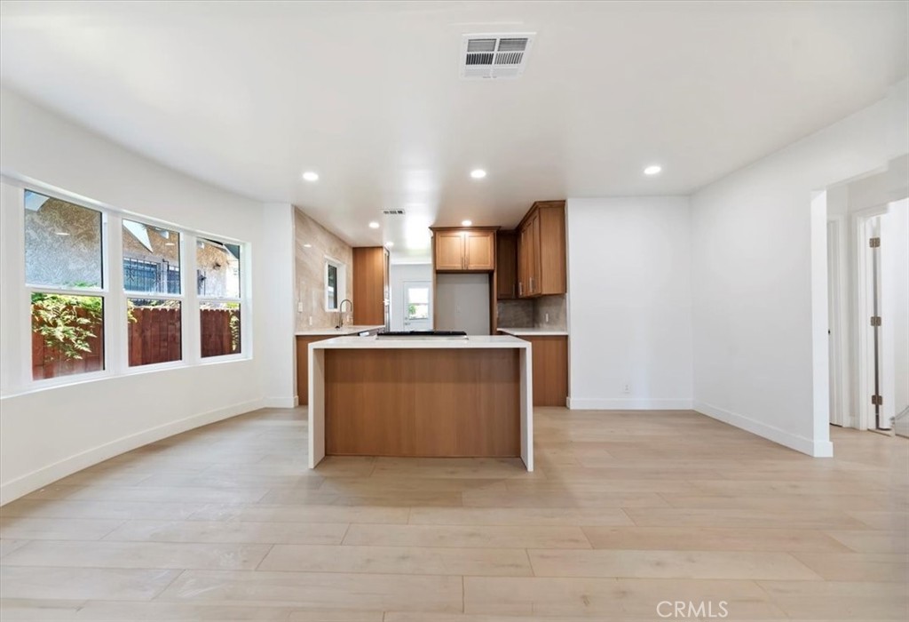 3011 5th Los Angeles, CA 90018 - Photo 16 of 44 a view of kitchen with kitchen island stainless steel appliances refrigerator sink and cabinets