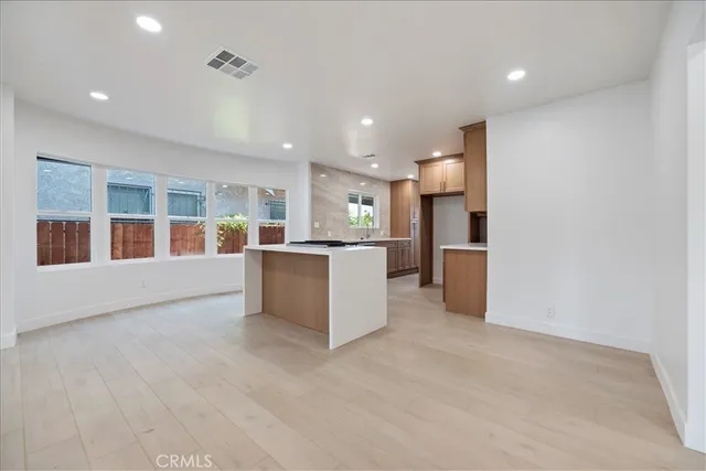 a large kitchen with a large counter top stainless steel appliances and cabinets