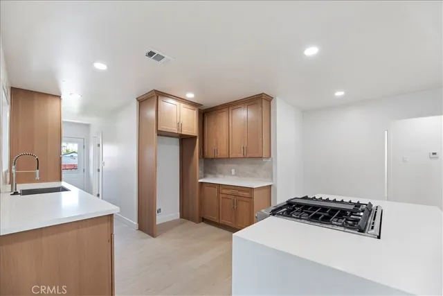 a kitchen with stainless steel appliances a sink and a refrigerator