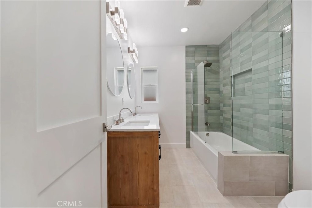 3011 5th Los Angeles, CA 90018 - Photo 25 of 44 a bathroom with a granite countertop sink a toilet and shower