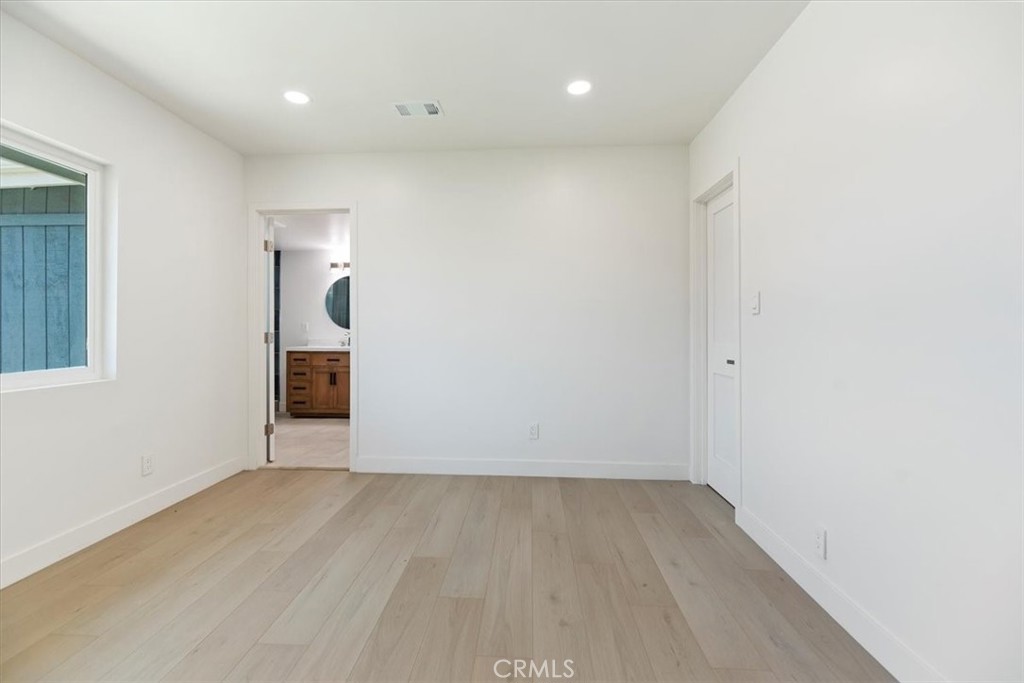 3011 5th Los Angeles, CA 90018 - Photo 32 of 44 an empty room with wooden floor and entrance