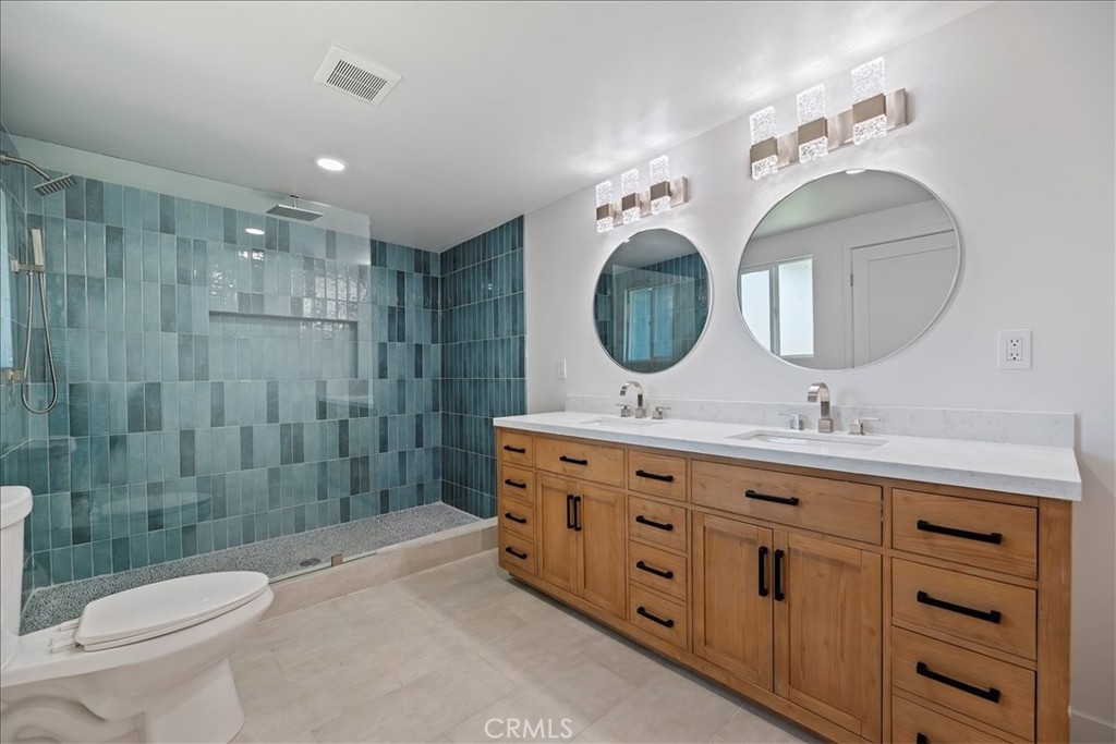 3011 5th Los Angeles, CA 90018 - Photo 35 of 44 a bathroom with a double vanity sink mirror and toilet