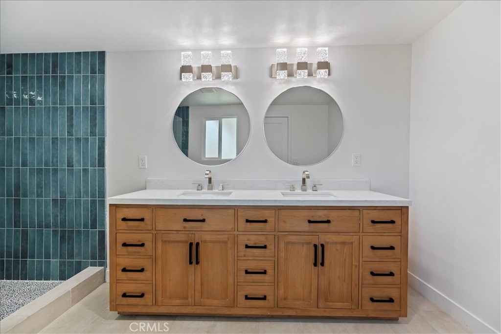 3011 5th Los Angeles, CA 90018 - Photo 37 of 44 a bathroom with a sink a mirror and a shower