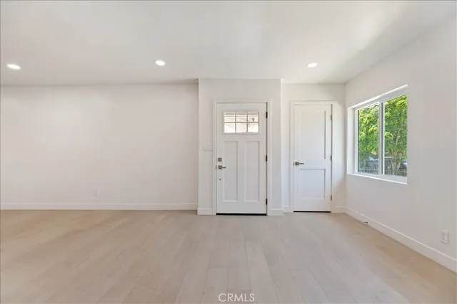 an empty room with windows and closet