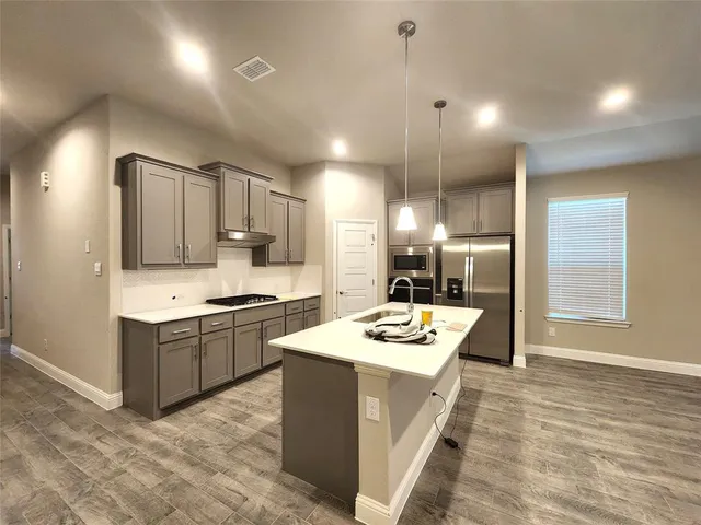 a kitchen with a sink stove and refrigerator