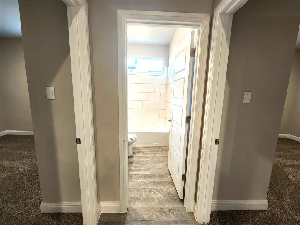 1521 Razorbill Road Denton, TX 76205 - Photo 14 of 31 a view of a bathroom from a hallway