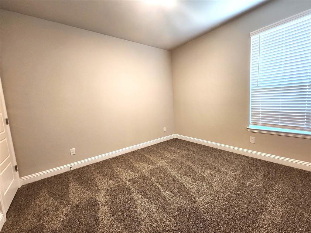 1521 Razorbill Road Denton, TX 76205 - Photo 17 of 31 an empty room with a window