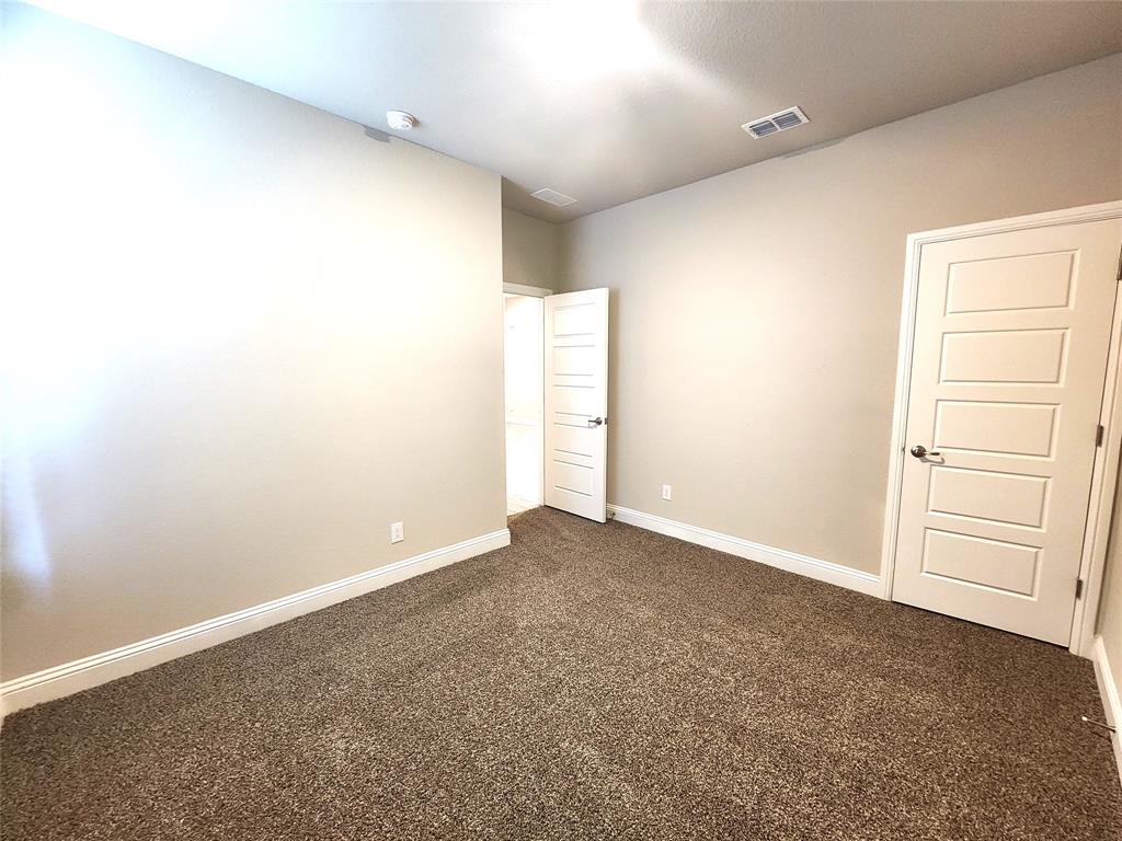 1521 Razorbill Road Denton, TX 76205 - Photo 18 of 31 an empty room with cabinet and cabinet