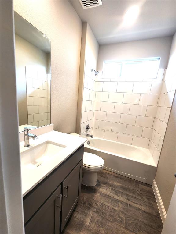 1521 Razorbill Road Denton, TX 76205 - Photo 19 of 31 a bathroom with a sink a toilet and bathtub